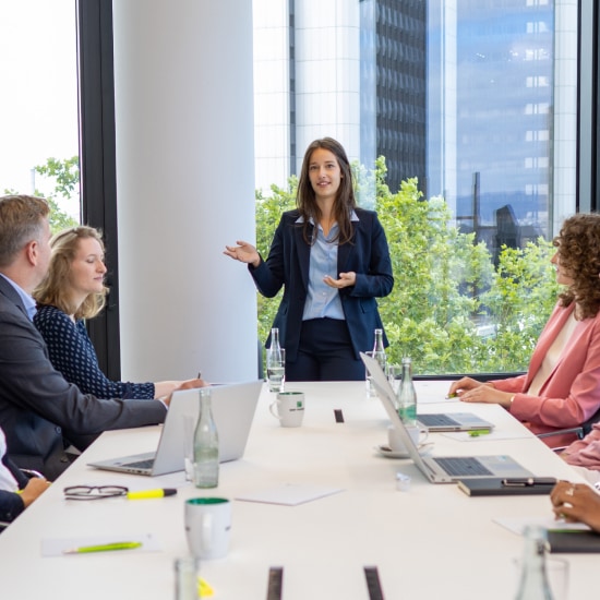 A woman stands at a lectern and gives a talk