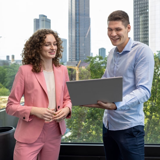 Photograph of two BNP Paribas employees at a big window