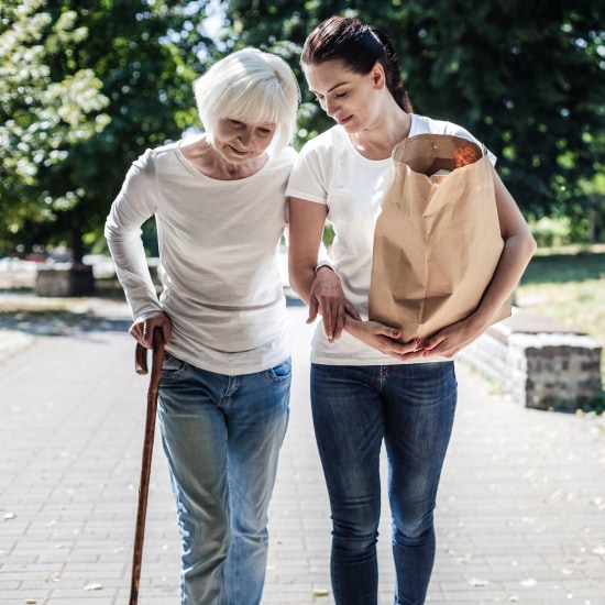 One woman supports another while walking