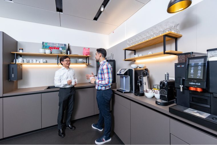 Two colleagues chatting in the tea kitchen