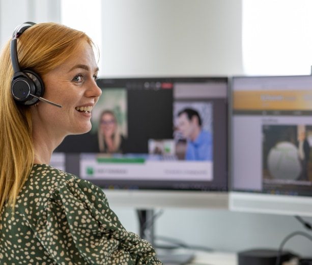 Employee with a headset working at a monitor