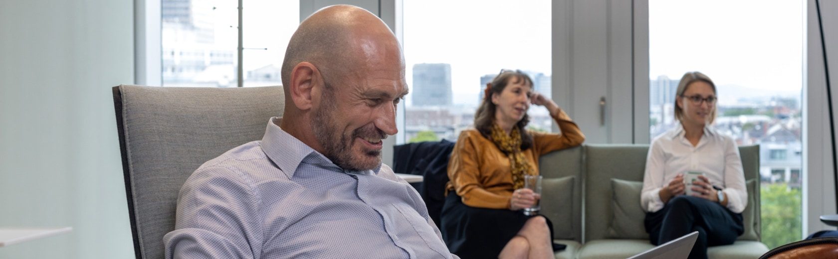 Three employees sitting in a conference room